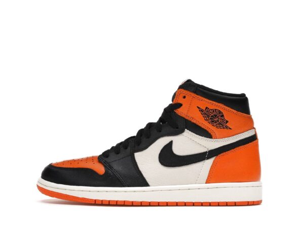 Chaussure montante orange noire et blanche avec une semelle blanche et des lacets noirs